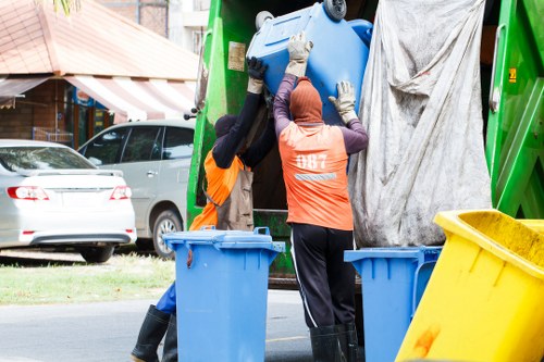 Charity volunteers loading reusable furniture and electronics